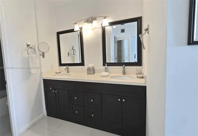 a bathroom with a double vanity sink mirror and