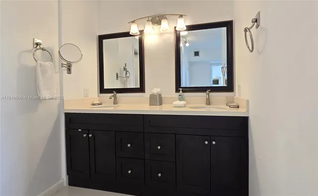 a bathroom with a double vanity sink and mirror
