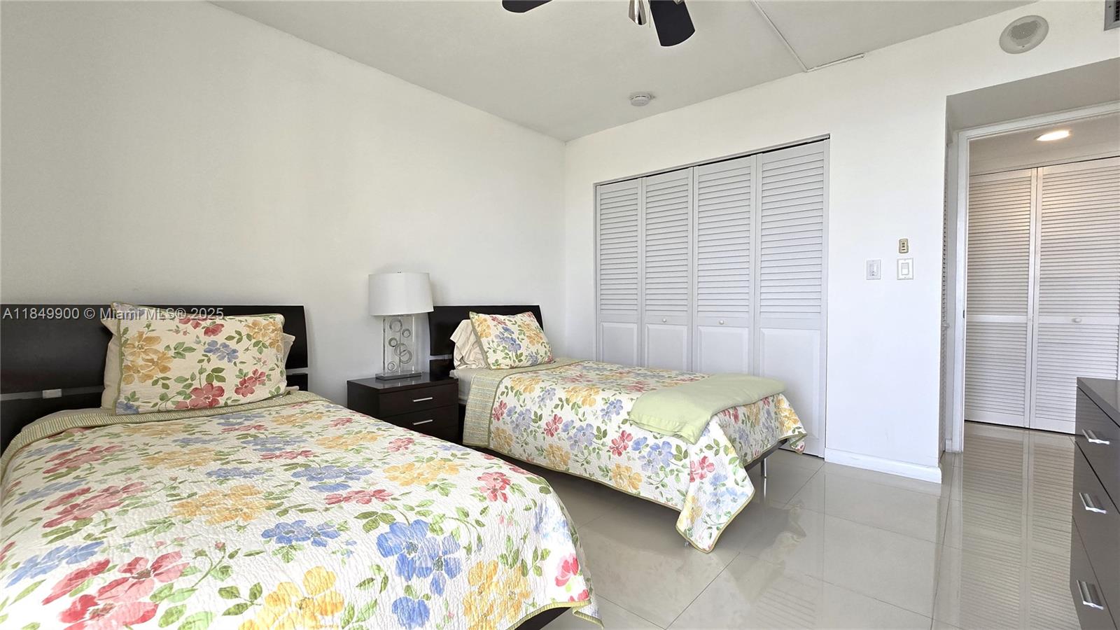 3731 North Country Club Drive, Unit 1825 Aventura, FL 33180 - Photo 21 of 25 a bedroom with two beds and painted walls