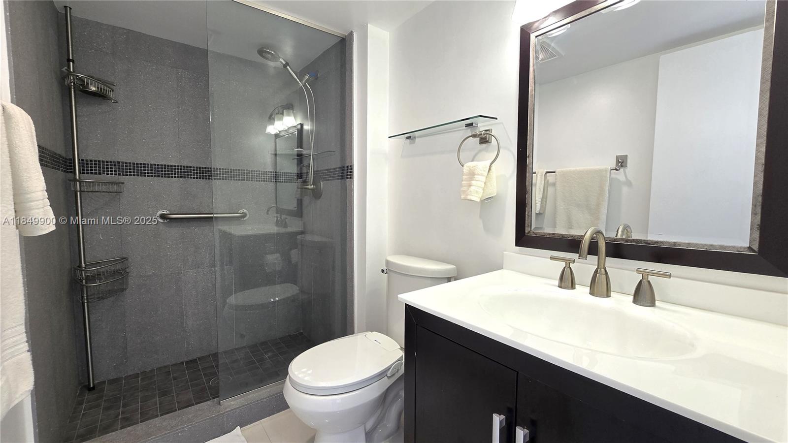 3731 North Country Club Drive, Unit 1825 Aventura, FL 33180 - Photo 22 of 25 a bathroom with a sink toilet and shower
