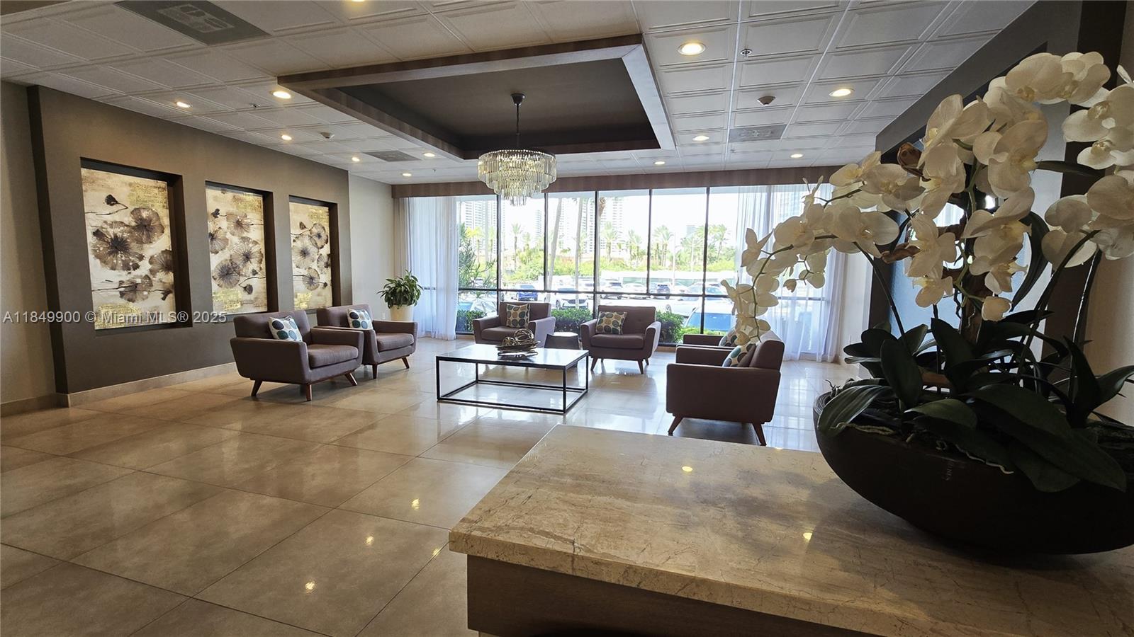 3731 North Country Club Drive, Unit 1825 Aventura, FL 33180 - Photo 23 of 25 a living room with furniture and a large window