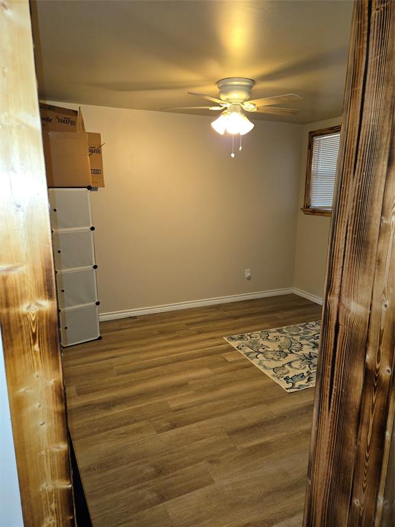242 Treasure Beach Comanche, TX 76442 - Photo 14 of 22 a view of empty room with wooden floor