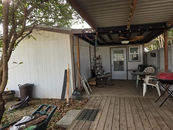 a view of a house with a tree in the background