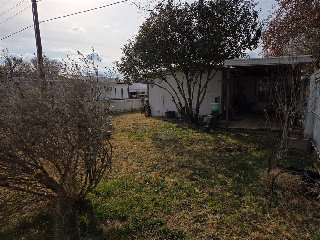 242 Treasure Beach Comanche, TX 76442 - Photo 16 of 22 a view of a house with a tree in the background