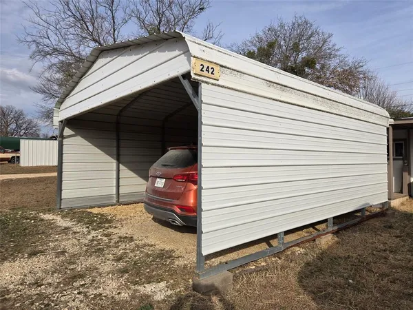 a view of a small car in front of house