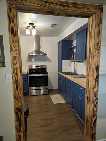a kitchen with stainless steel appliances granite countertop a stove and a sink