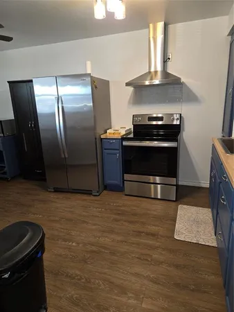 a kitchen with granite countertop a stove and a refrigerator