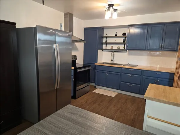 a kitchen with stainless steel appliances granite countertop a refrigerator and a sink