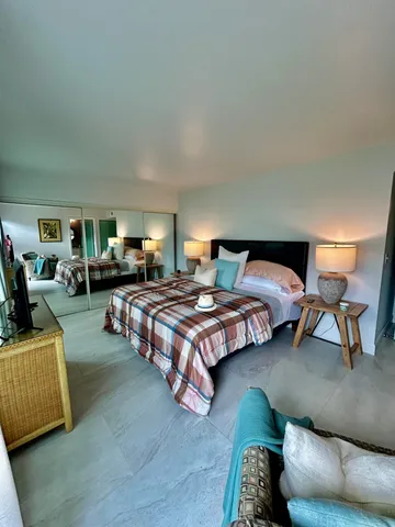 a bedroom with a bed and a couch