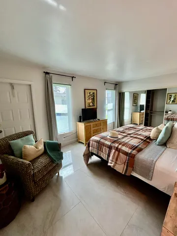 a bedroom with a bed couch and window