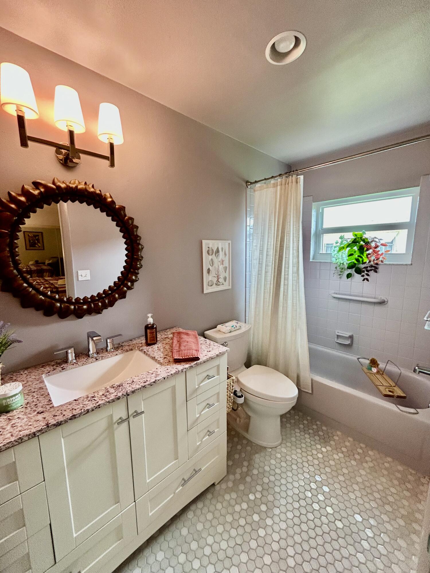5289 Lake Front Boulevard, Unit D Delray Beach, FL 33484 - Photo 14 of 14 a bathroom with a granite countertop sink mirror vanity and toilet