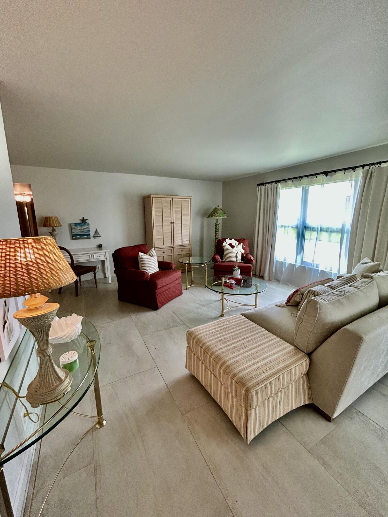 5289 Lake Front Boulevard, Unit D Delray Beach, FL 33484 - Photo 6 of 14 a living room with furniture and a large window