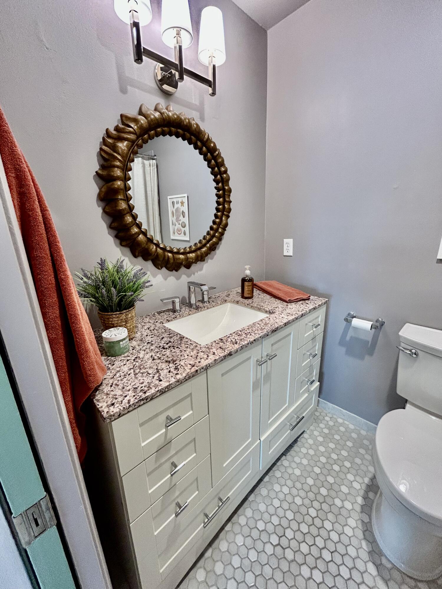 5289 Lake Front Boulevard, Unit D Delray Beach, FL 33484 - Photo 10 of 14 a bathroom with a granite countertop sink and mirror