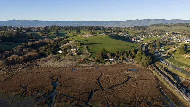 an aerial view of a house with a yard
