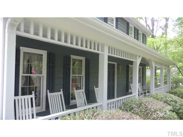 The rocking chair front porch is shaded by all of the large trees and is a perfect place to set, enjoy your favorite book and nature at the same time. Porch