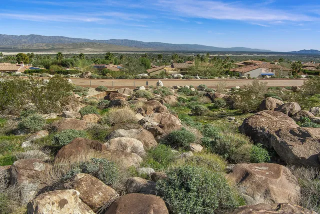a backyard of a house with a yard and mountain view