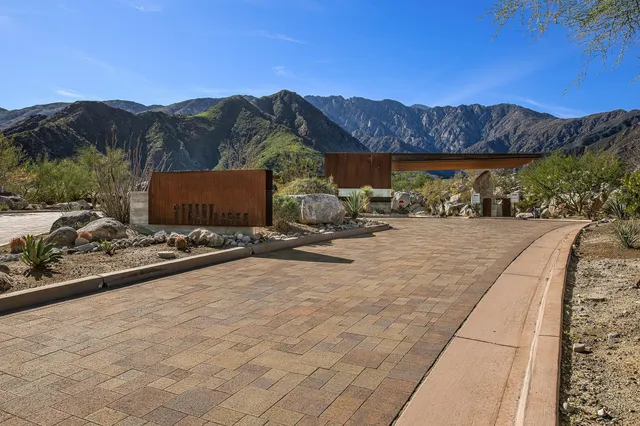 a view of a dry yard with mountains in the background
