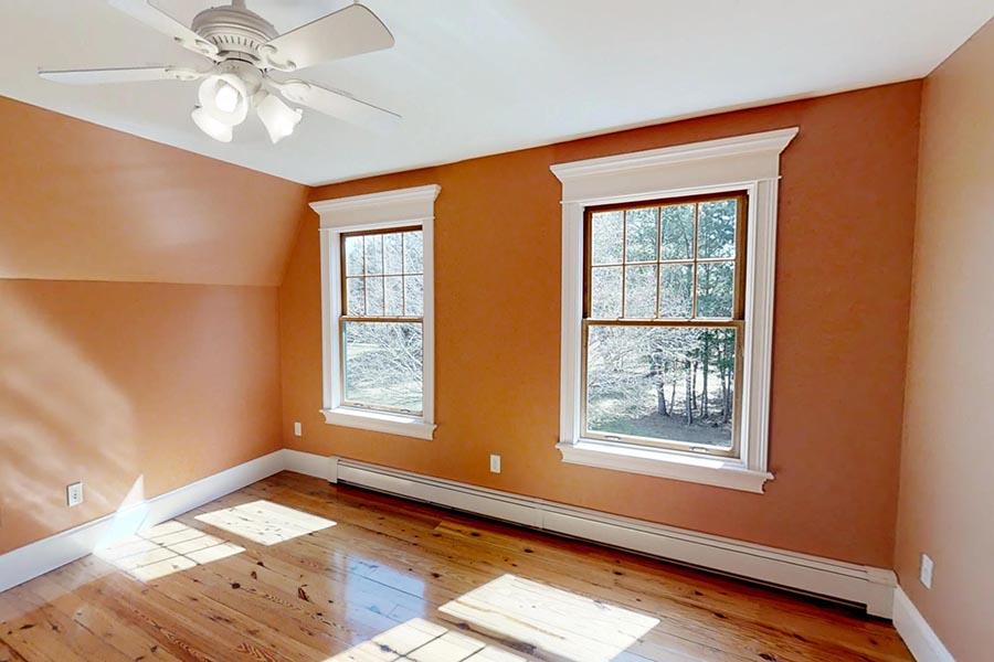 30 Vaughan Hill Road Rochester, MA 02770 - Photo 16 of 22 a view of an empty room with a window and wooden floor