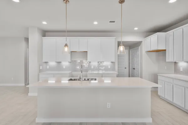 a large kitchen with stainless steel appliances kitchen island a large island