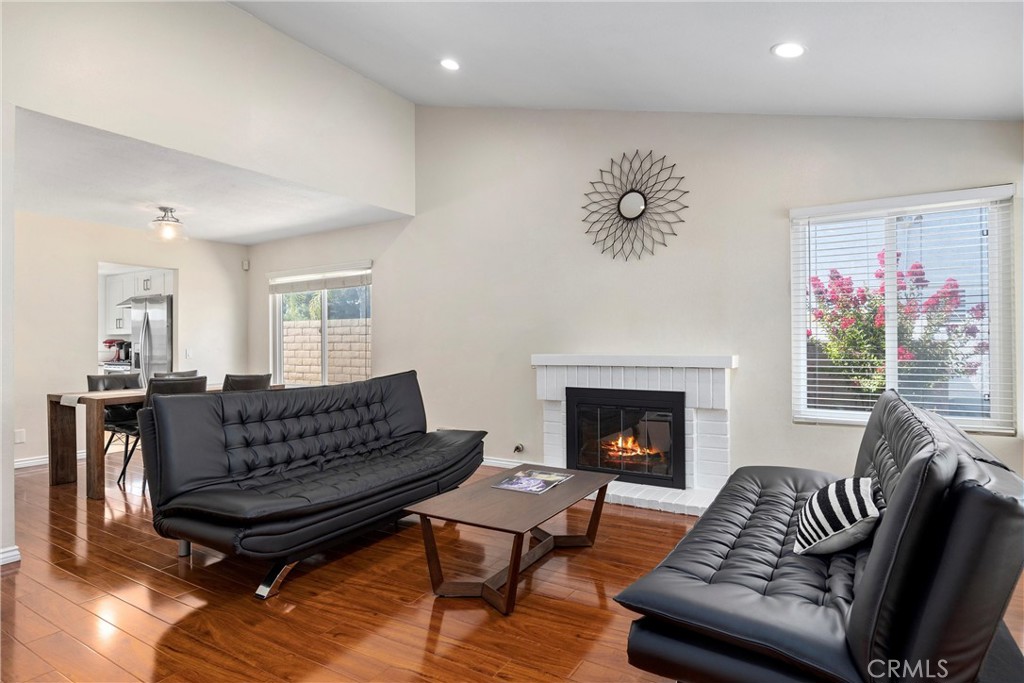 1415 Rolling Knoll Road Diamond Bar, CA 91765 - Photo 5 of 24 a living room with furniture a fireplace and a large mirror with wooden floor