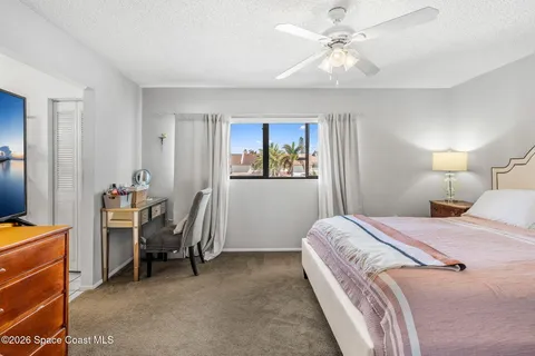 a room with a bed and a chandelier