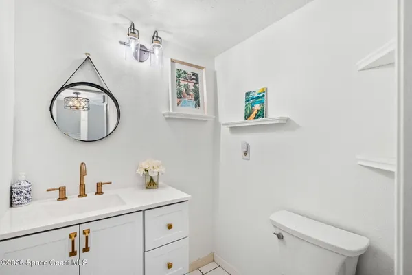 a bathroom with a toilet a sink and a mirror