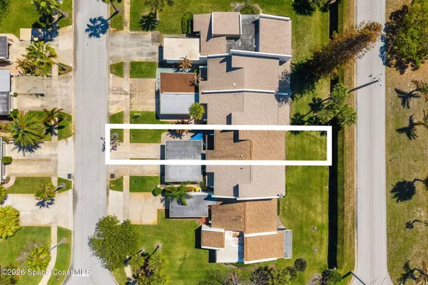 aerial view of residential houses with outdoor space and street view