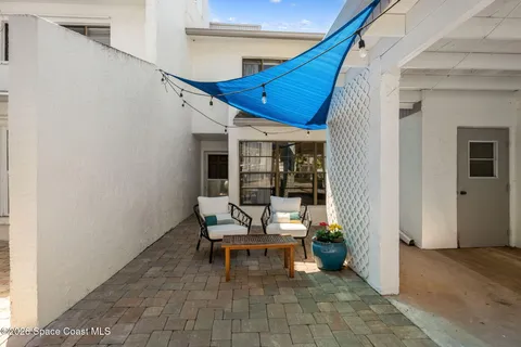 a view of a patio with table and chairs and wooden floor