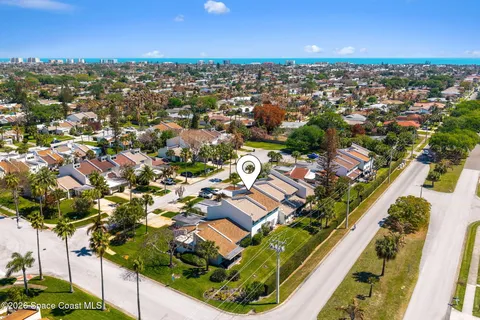 an aerial view of residential houses with outdoor space