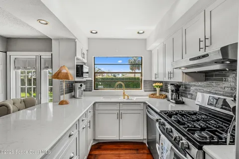 a kitchen with a sink stove and cabinets