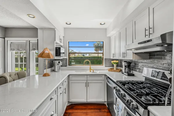 a kitchen with a sink stove and cabinets