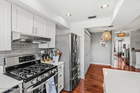 a kitchen with stainless steel appliances granite countertop a stove and a refrigerator