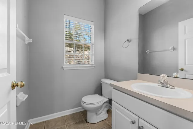 a bathroom with a toilet a sink and a window