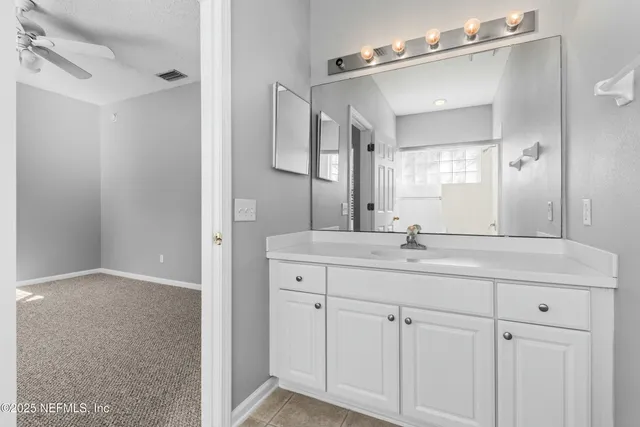 a bathroom with a double vanity sink and mirror