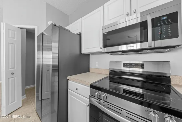 a kitchen with stainless steel appliances and cabinets