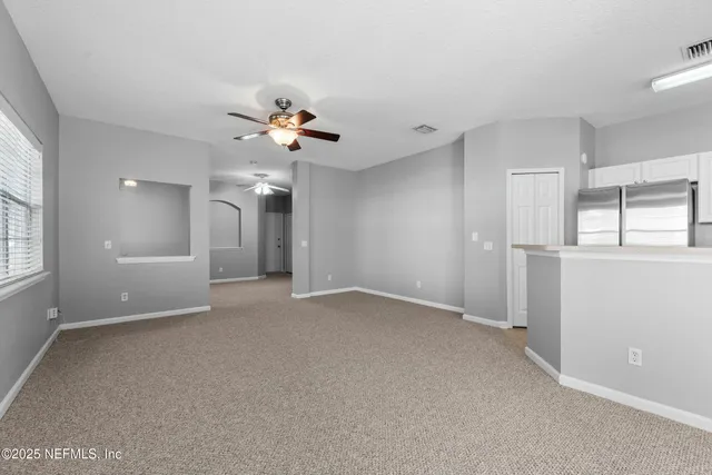 a view of an empty room with a window