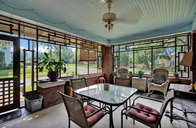 a dining room with furniture a chandelier and glass door