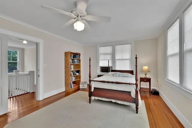 a spacious bedroom with a bed and a chandelier