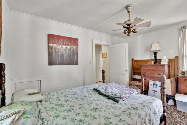 a bedroom that has a bed and a table in it