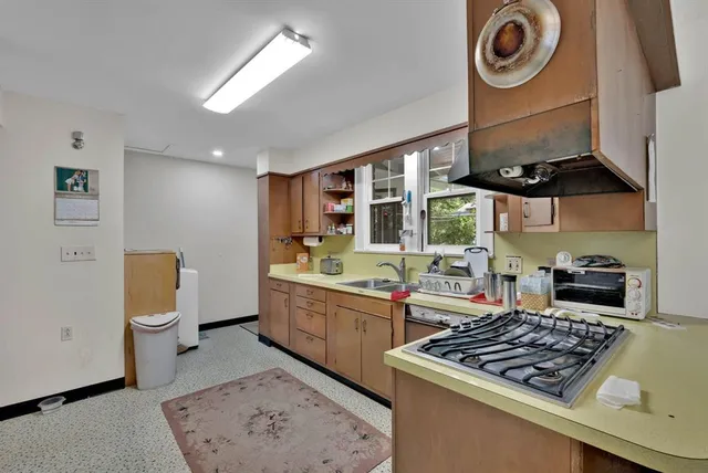 a kitchen with stove and cabinets