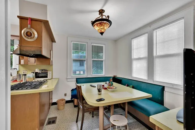 a view of a dining room with furniture and window