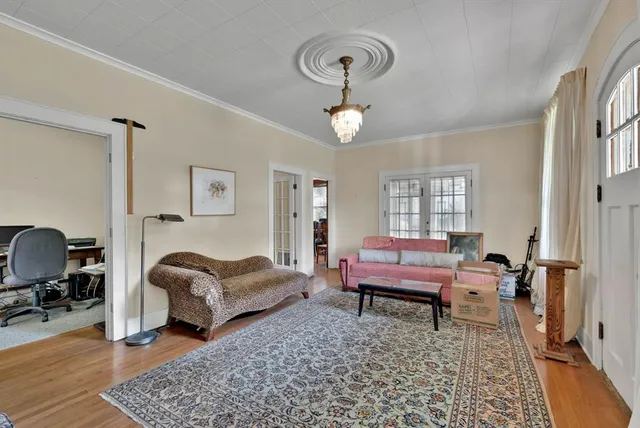 a living room with furniture a rug and a window