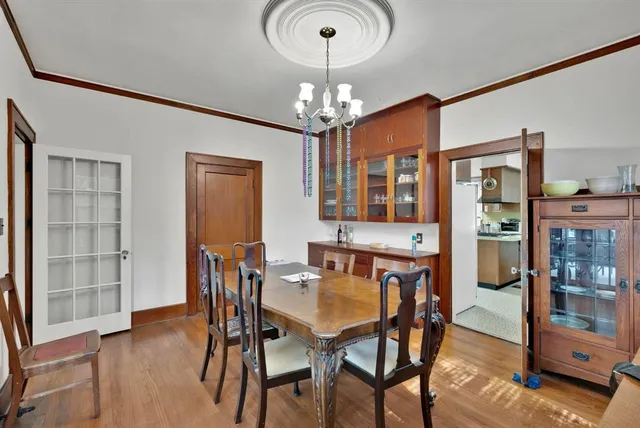 a view of a dining room with furniture and chandelier
