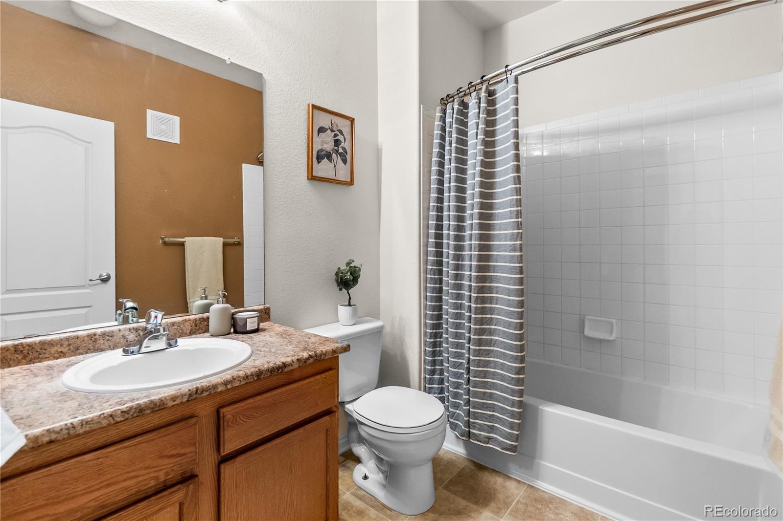 18669 Stroh Road, Unit 10204 Parker, CO 80134 - Photo 12 of 24 a bathroom with a sink toilet and shower
