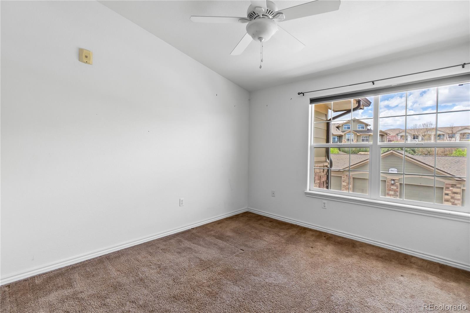 18669 Stroh Road, Unit 10204 Parker, CO 80134 - Photo 13 of 24 an empty room with a window
