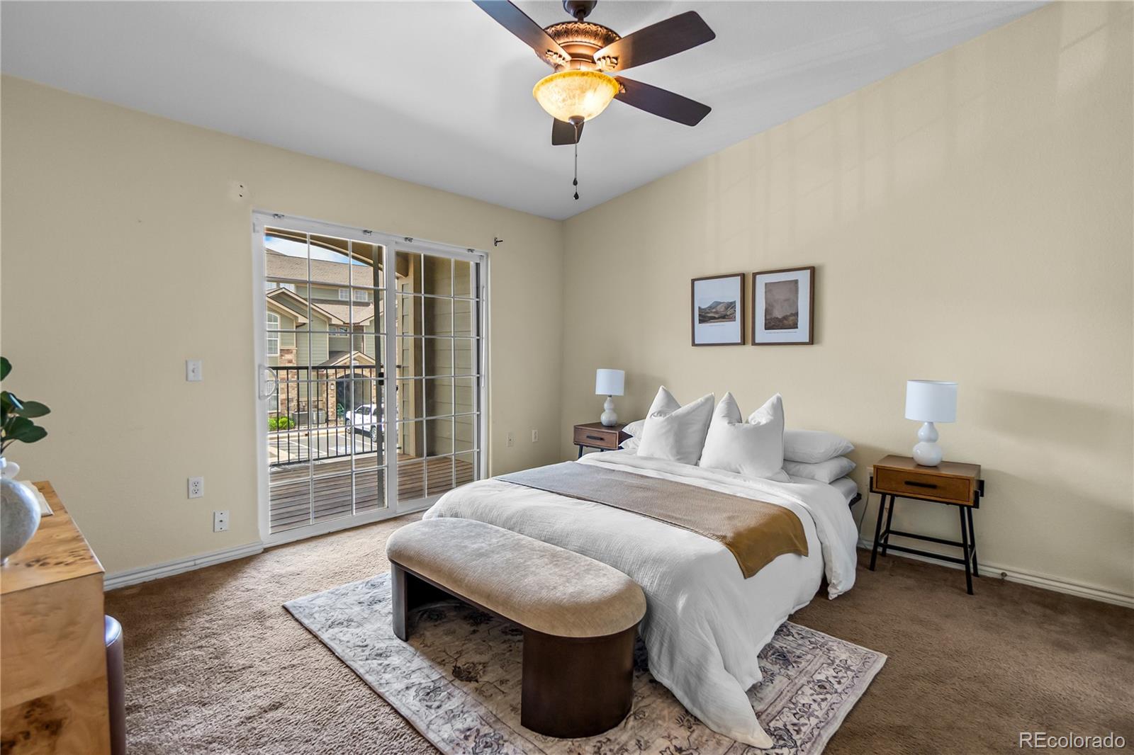 18669 Stroh Road, Unit 10204 Parker, CO 80134 - Photo 15 of 24 a bedroom with a bed a chandelier and a window