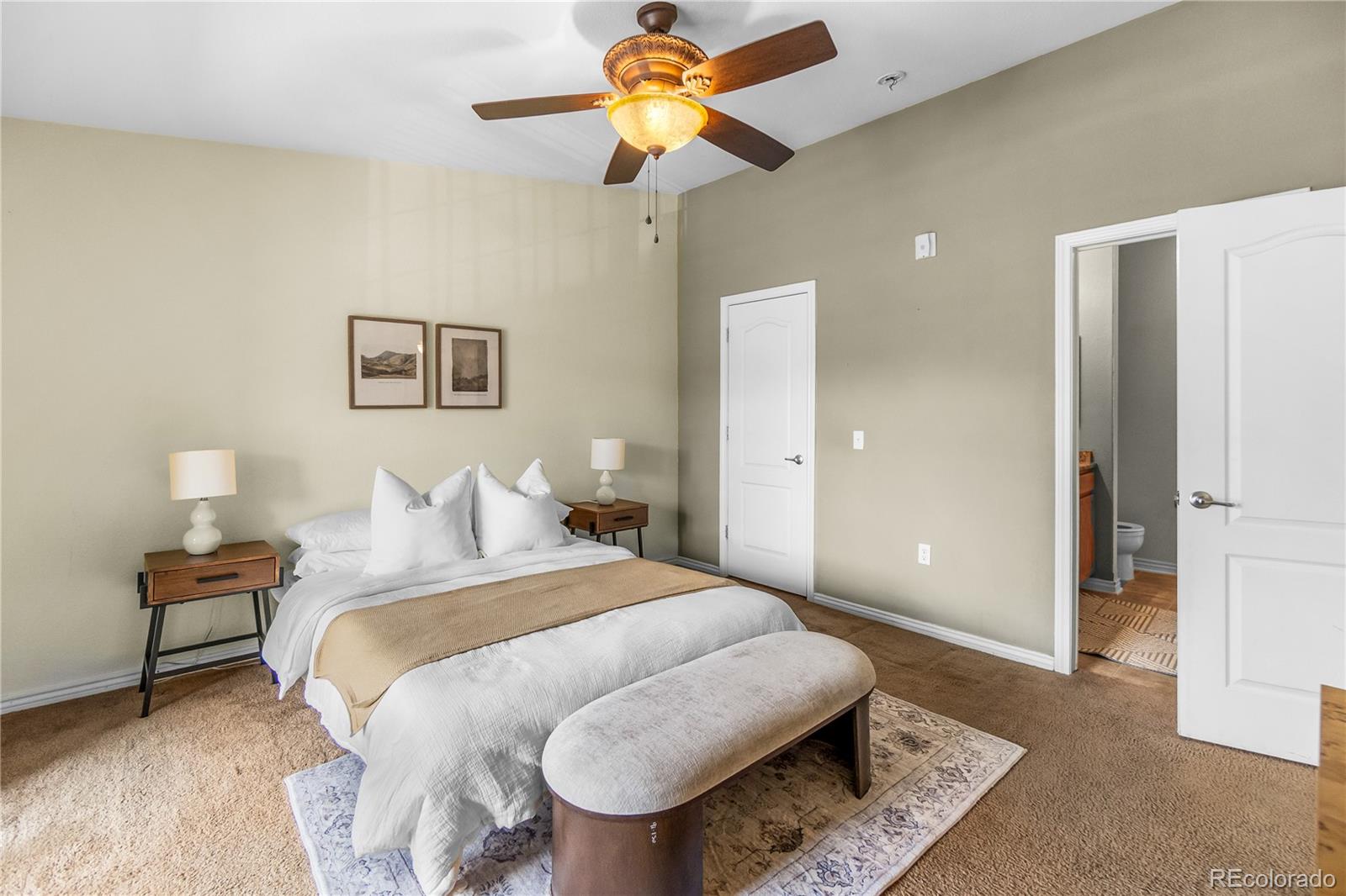 18669 Stroh Road, Unit 10204 Parker, CO 80134 - Photo 16 of 24 a bedroom with a bed and a chandelier