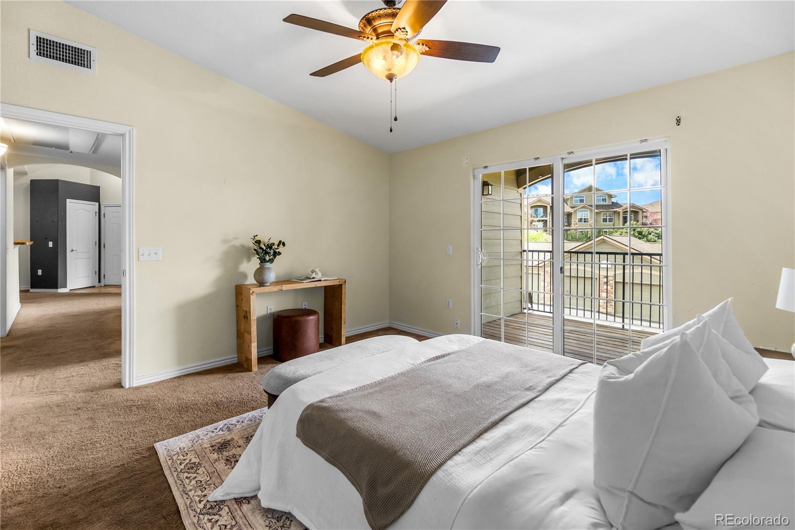 18669 Stroh Road, Unit 10204 Parker, CO 80134 - Photo 17 of 24 a bedroom with a bed and a chandelier
