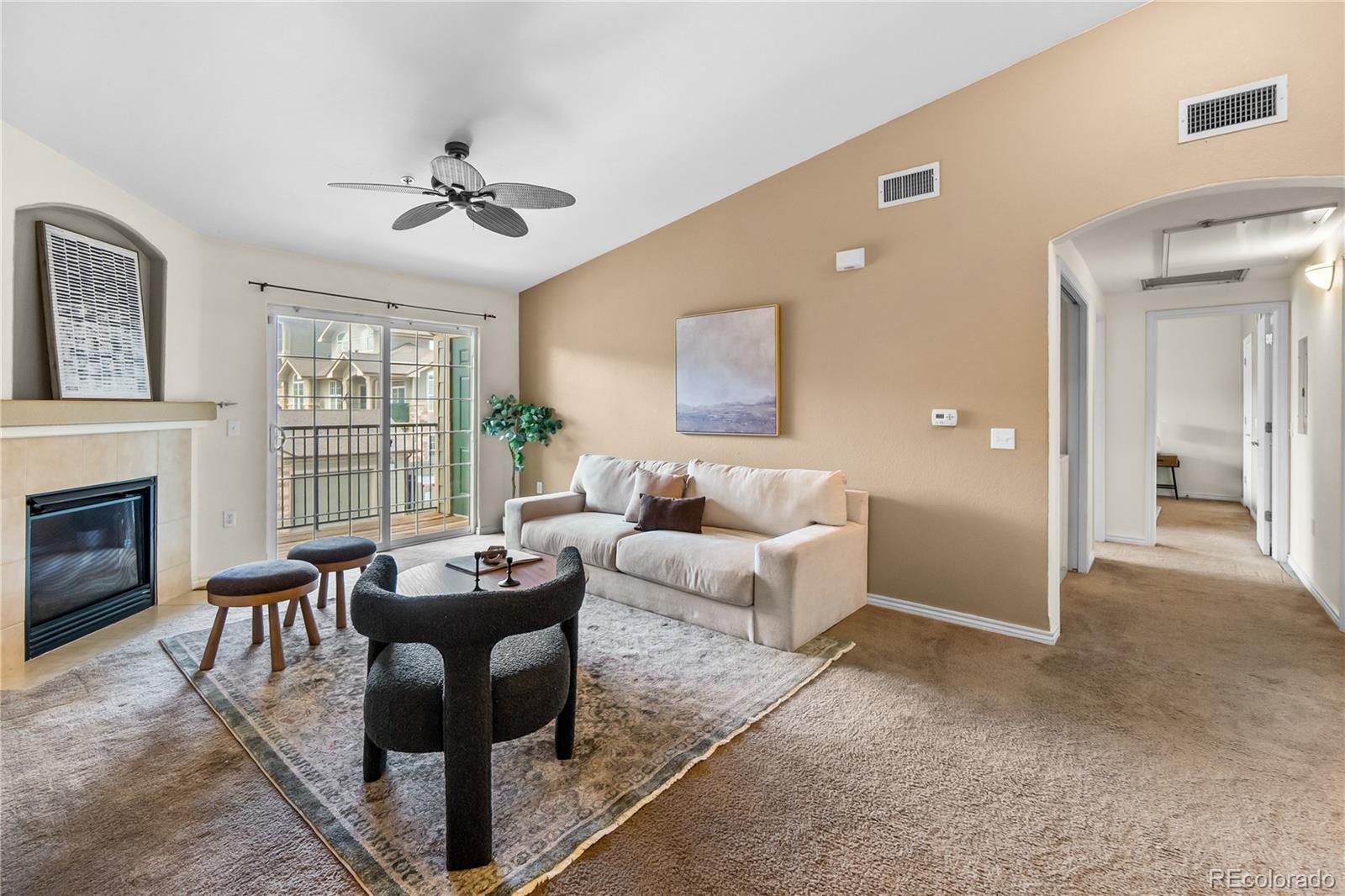 18669 Stroh Road, Unit 10204 Parker, CO 80134 - Photo 2 of 24 a living room with furniture and a fireplace