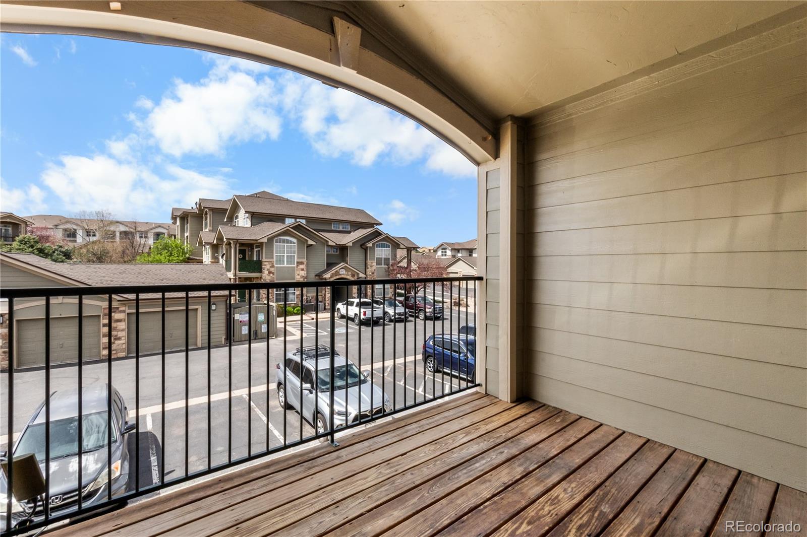 18669 Stroh Road, Unit 10204 Parker, CO 80134 - Photo 22 of 24 a view of a balcony with wooden floor